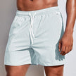 Light green casual striped FJØRNA men's boardshorts with drawstring and side slit hem, perfect for beach and pool wear.