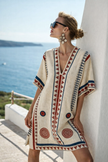 Women's loose fit summer beach dress by FJØRNA, lightweight and casual with a relaxed style, shown in a natural outdoor setting.