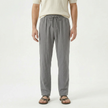Men's linen drawstring trousers by FJØRNA, featuring lightweight fabric, relaxed fit, and adjustable waistband in neutral color.