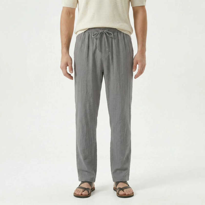 Men's linen drawstring trousers by FJØRNA, featuring lightweight fabric, relaxed fit, and adjustable waistband in neutral color.