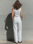 FJØRNA cotton blend sleeveless jumpsuit for women with V-neck, tailored fit, and single-breasted design, styled as pants.