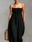 FJØRNA linen blend strapless women’s jumpsuit with loose fit and tie closure, displayed as stylish women's pants in the image.