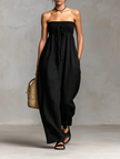 Women’s linen blend strapless jumpsuit by FJØRNA featuring loose fit, tie closure, and stylish pant design.