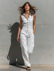 FJØRNA women's cotton blend sleeveless jumpsuit with V-neck, tailored fit, single-breasted design, shown in natural fabric texture.