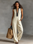 FJØRNA linen blend sleeveless jumpsuit for women with stand collar and embroidery detail, shown hanging on a white background.