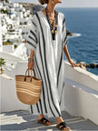 Loose summer long kaftan dress for women by FJØRNA, flowing and comfortable, shown in a relaxed fit with vibrant fabric.