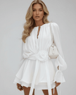 FJØRNA floral mini dress for women featuring 3D floral pattern, white flare sleeves, and a waist belt, perfect for elegant fashion.