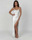 Elegant white satin maxi dress by FJØRNA with high slit, asymmetrical design, sleek silhouette, perfect for evening wear.