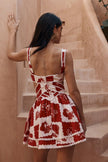 FJØRNA Leila printed cut-out mini dress in red with floral pattern and stylish side cut-outs, sleeveless design, perfect for summer.