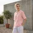 FJØRNA women's summer blouse with short sleeves and linen fabric, styled casually with a relaxed fit in a bright outdoor setting.