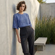 FJØRNA summer floral lace blouse for women, lightweight top with delicate floral pattern, worn casually outdoors.