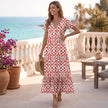 FJØRNA ruffled hem A-line maxi dress for women featuring a flowy silhouette and stylish ruffle details in a natural outdoor setting.