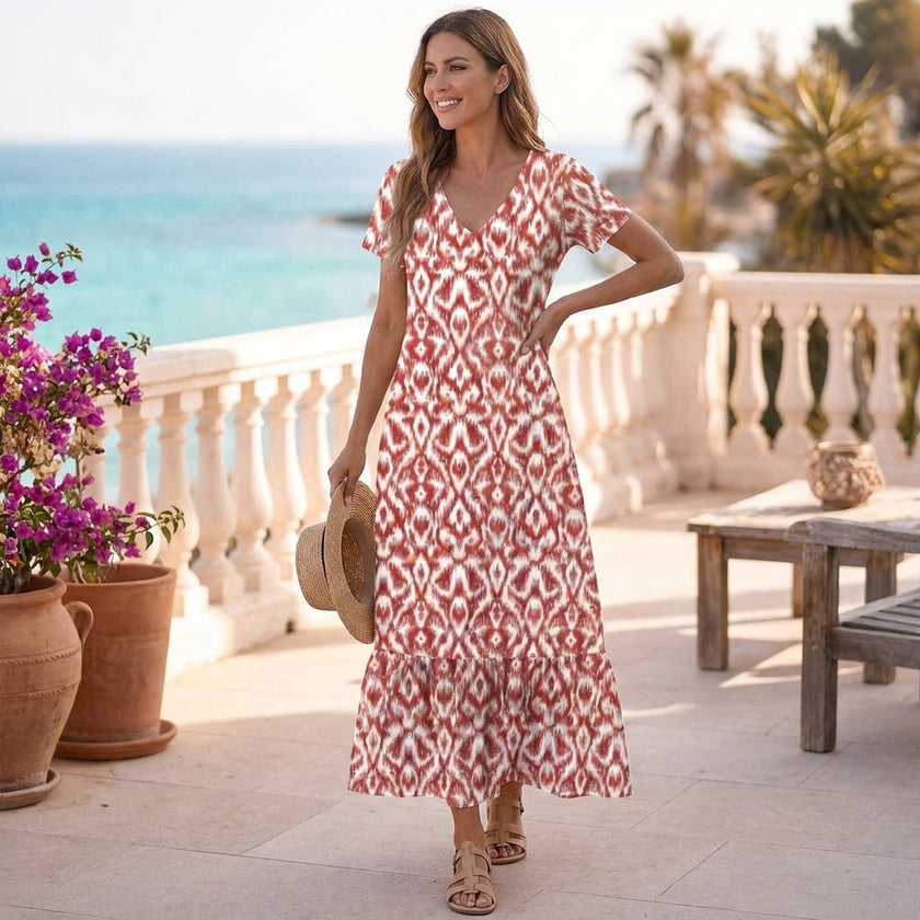 FJØRNA ruffled hem A-line maxi dress for women featuring a flowy silhouette and stylish ruffle details in a natural outdoor setting.