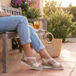 FJØRNA women's orthopedic peep-toe wedge sandals featuring supportive design and stylish leather straps in a casual outdoor setting.
