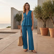 FJØRNA women's summer two-piece set with wide-leg pants and V-neck top, styled in a casual outdoor setting.