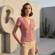 FJØRNA summer women's blouse with gingham pattern, V-neck style, worn casually with sleeves rolled up and a relaxed fit.