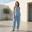 FJØRNA lightweight two-piece halter V-neck suit with wide-leg trousers, styled in a casual outdoor setting.