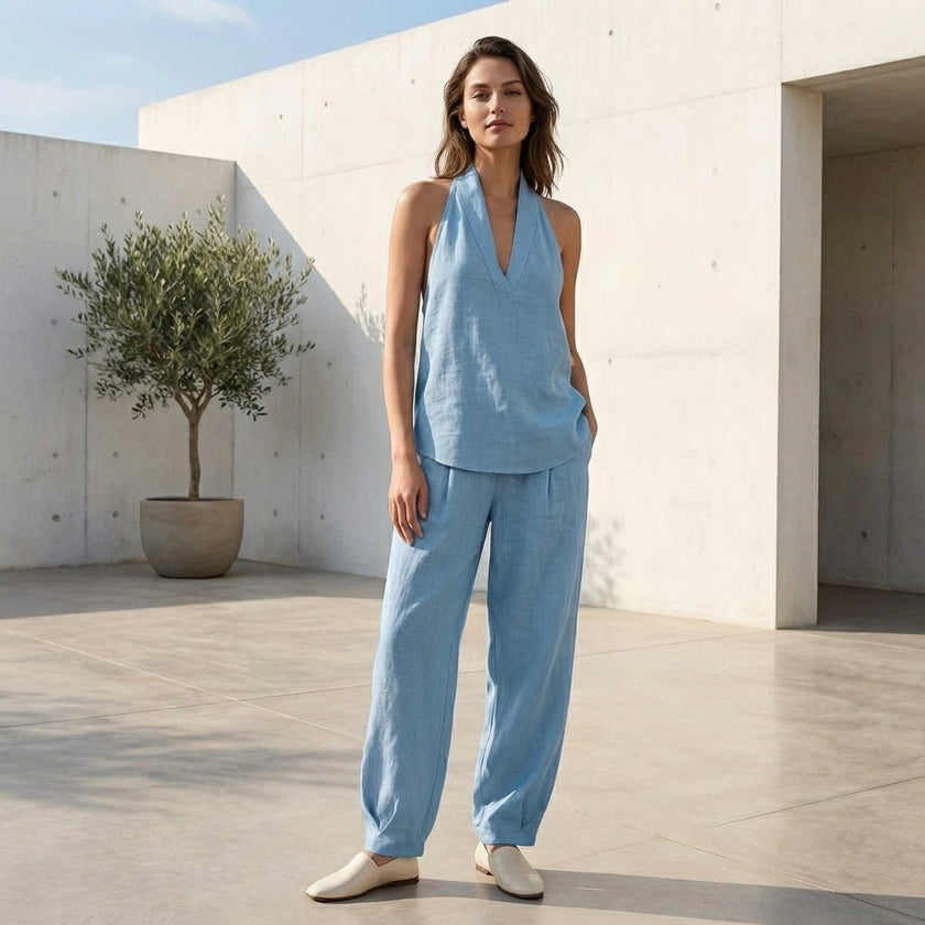 FJØRNA lightweight two-piece halter V-neck suit with wide-leg trousers, styled in a casual outdoor setting.