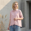 FJØRNA women's denim ruffle summer blouse styled casually, featuring ruffled details and lightweight fabric.
