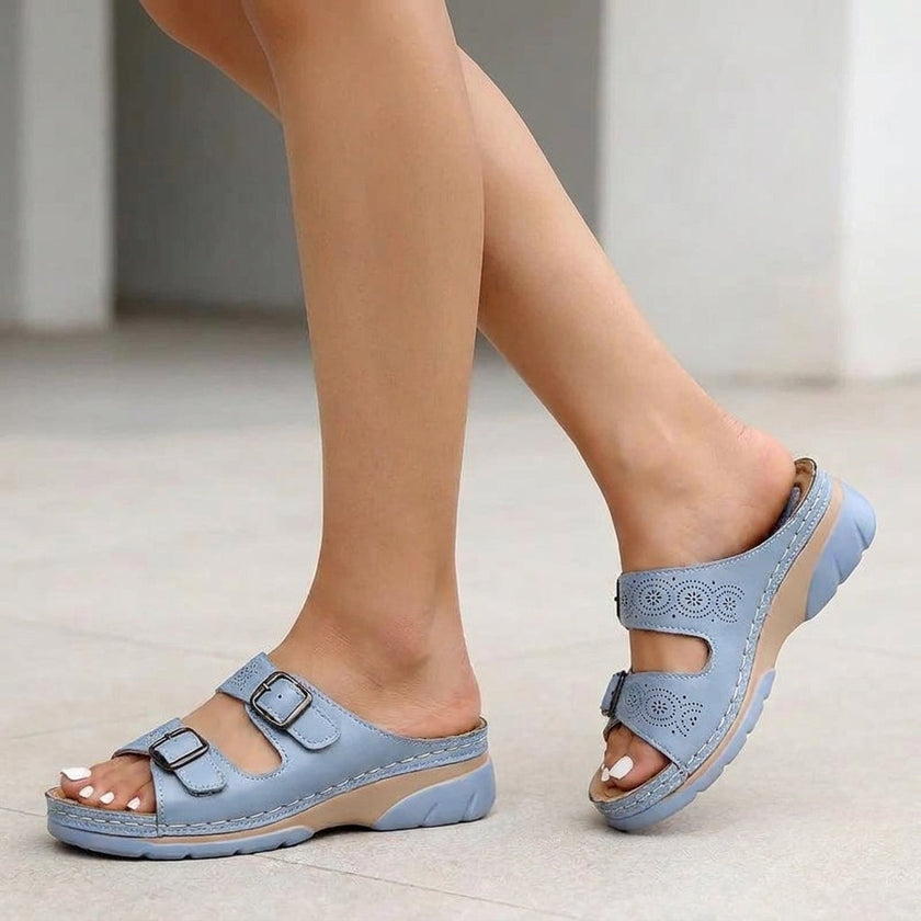 Light blue FJØRNA orthopedic buckle platform slide sandals for women, featuring a comfortable slip-on design with adjustable straps.