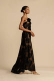 FJØRNA Lindsay floral printed one-shoulder maxi dress in black, featuring a flowing silhouette and vibrant floral pattern.