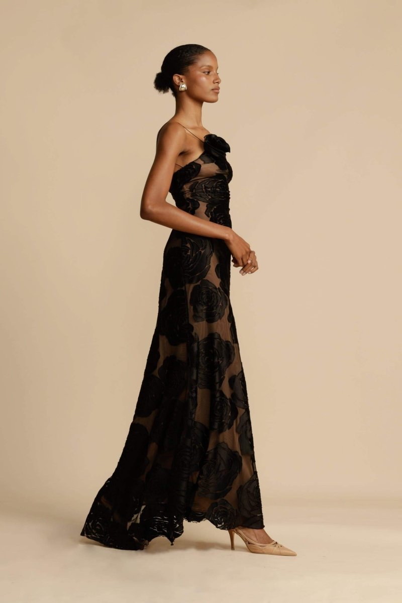 FJØRNA Lindsay floral printed one-shoulder maxi dress in black, featuring a flowing silhouette and vibrant floral pattern.