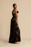 FJØRNA Lindsay floral printed one-shoulder maxi dress in black, featuring a flowing silhouette and elegant floral pattern.