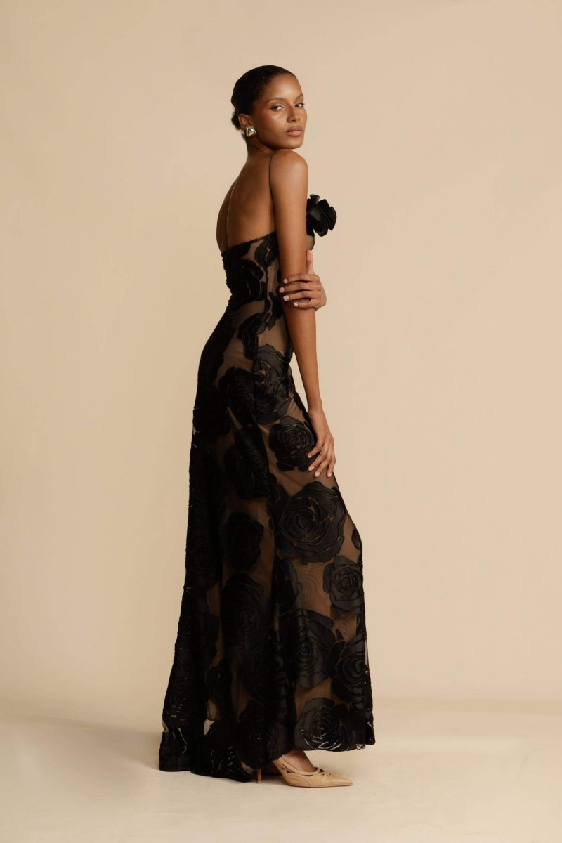 FJØRNA Lindsay floral printed one-shoulder maxi dress in black, featuring a flowing silhouette and elegant floral pattern.