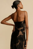 FJØRNA Lindsay floral printed one-shoulder maxi dress in black with a flowing silhouette and vibrant floral pattern.