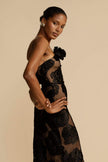 FJØRNA Lindsay floral printed one-shoulder maxi dress in black with flowing fabric and vibrant floral pattern.
