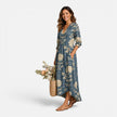 Women's playful floral maxi dress by FJØRNA, featuring lightweight linen fabric and vibrant floral pattern for summer wear.