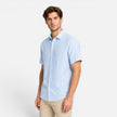 Men's FJØRNA linen shirt with short sleeves and button-up front, made from breathable cotton blend fabric.