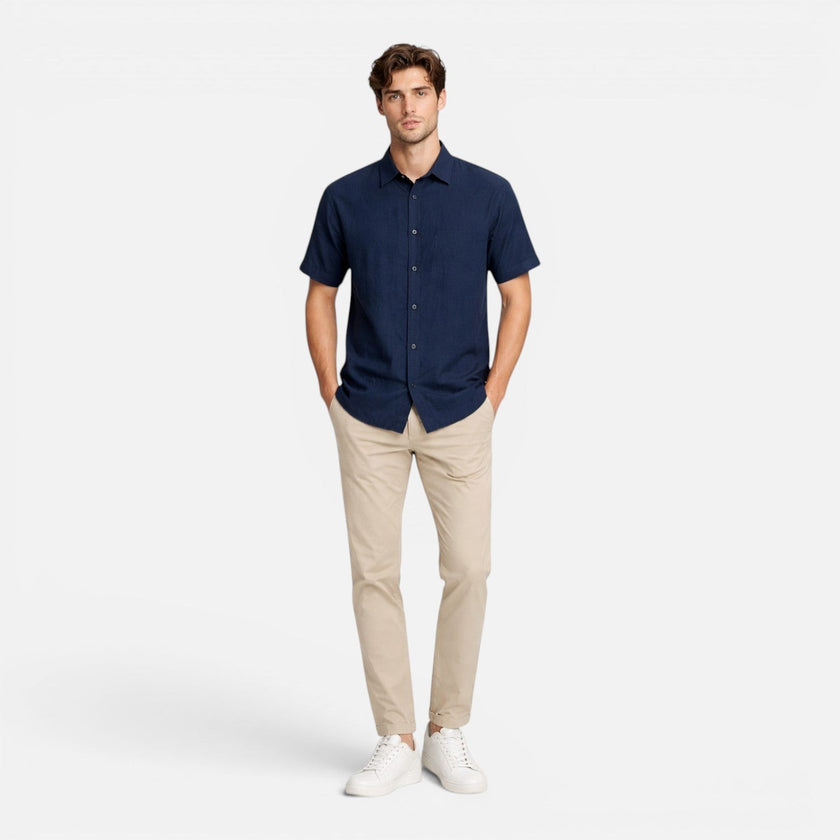 Men's FJØRNA linen shirt with short sleeves, breathable cotton blend fabric, button-up design, suitable for warm weather.