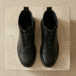 FJØRNA men's leather combat boots with orthopedic support and side zipper, featuring sturdy design and durable sole.