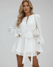 FJØRNA floral mini dress for women with 3D floral pattern, belt, flare sleeves, and elegant white fabric.