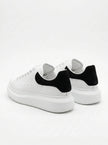 FJØRNA men's white lace-up trainers with minimalist design, back view showing sleek style and comfortable sole for everyday wear.