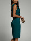 Elegant FJØRNA Amelie White Dress with a deep V back, side slit, perfect for evening wear, shown on a model.
