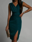 Elegant FJØRNA Amelie White Dress featuring a deep V-back, side slit, and sophisticated evening style.