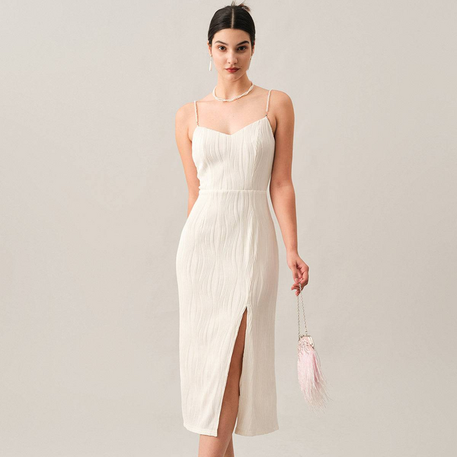 White pearl-strap textured midi dress by FJØRNA, stylish for cocktail and special occasions, featuring elegant fabric details.