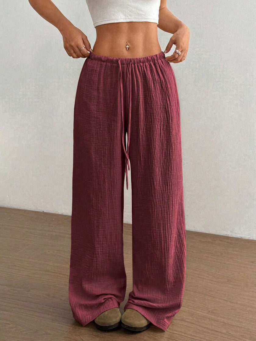 FJØRNA Mirabelle women's wide-leg casual pants with drawstring waist, lightweight fabric, and relaxed fit in neutral color.
