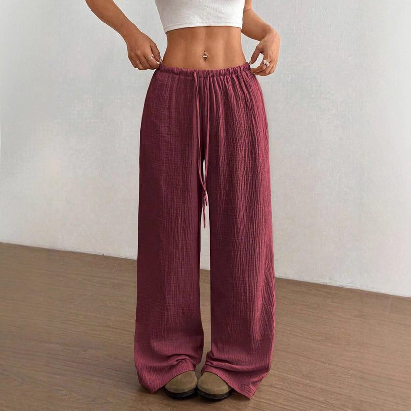 FJØRNA Mirabelle women's wide-leg casual pants with drawstring waist, lightweight fabric and relaxed fit, shown in neutral color.
