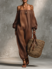 FJØRNA linen blend strapless jumpsuit with long sleeves and wide-leg pants worn by a female model walking on a runway.