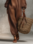 FJØRNA linen blend strapless jumpsuit for women, full-body shot of a model walking in a long-sleeve, wide-leg pants jumpsuit.