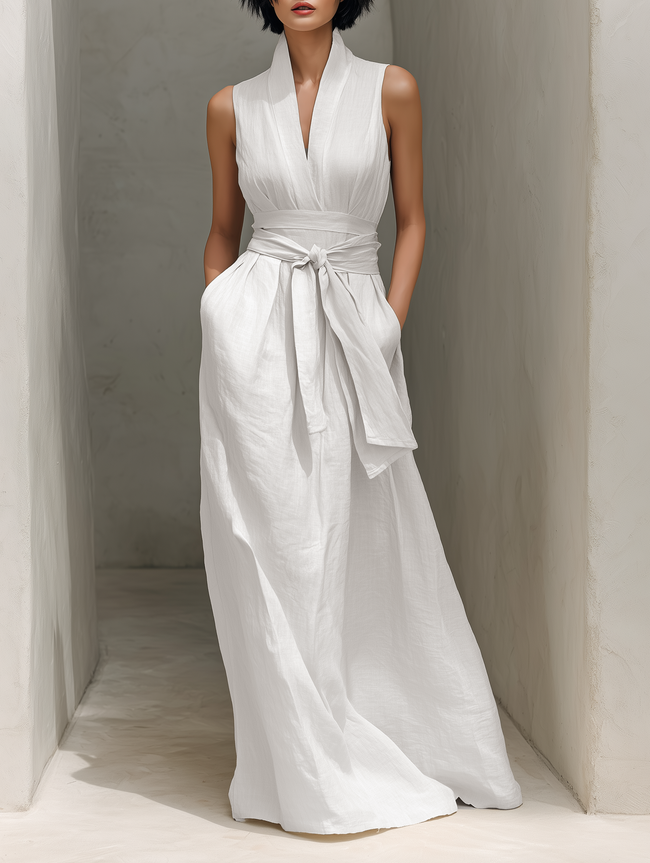 Full-body image of a woman in a FJØRNA linen V-neck maxi dress, showcasing a chic, relaxed fit and lightweight fabric.