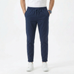 Men's stretchable comfort trousers by FJØRNA, showing the flexible, tailored design and fabric texture of the men's pant in natural pose.