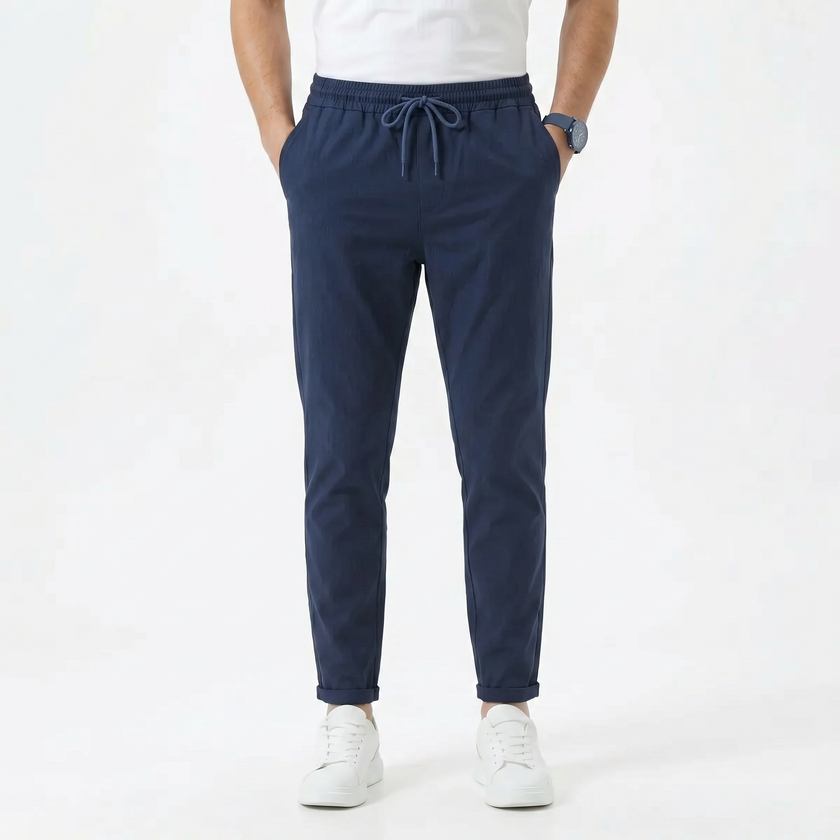 Men's stretchable comfort trousers by FJØRNA, showing the flexible, tailored design and fabric texture of the men's pant in natural pose.