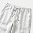Men's FJØRNA breathable linen trousers with a relaxed fit, featuring a light, natural fabric and stylish design.