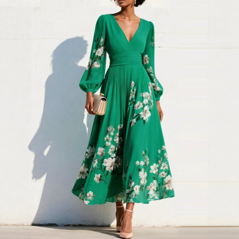 FJØRNA floral print long-sleeved V-neck pleated dress featuring elegant floral design and flowing fabric.