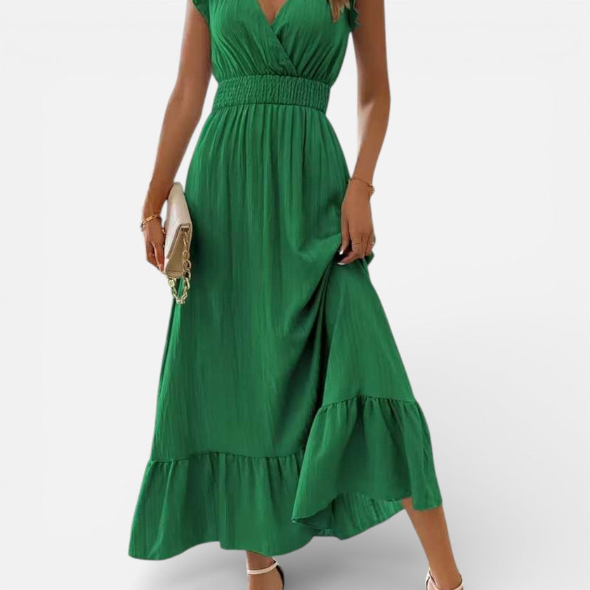 Women's sleeveless maxi dress by FJØRNA, flowy fit and timeless style, shown in a natural, elegant pose.