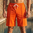 Men's relaxed knee-length tailored shorts by FJØRNA in orangered, featuring adjustable waist and stylish seam details.